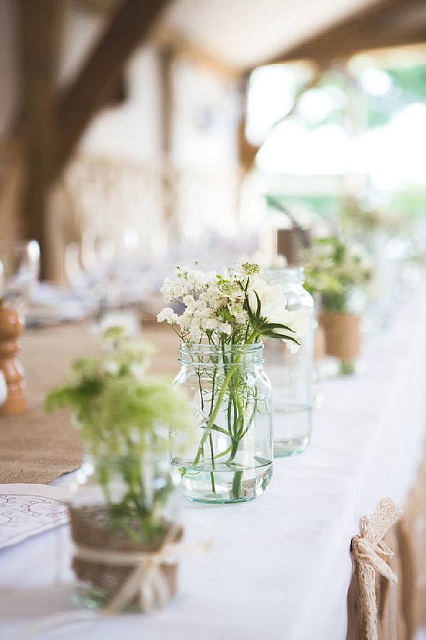 cripps barn wedding flowers top table with jam jars vases hessian