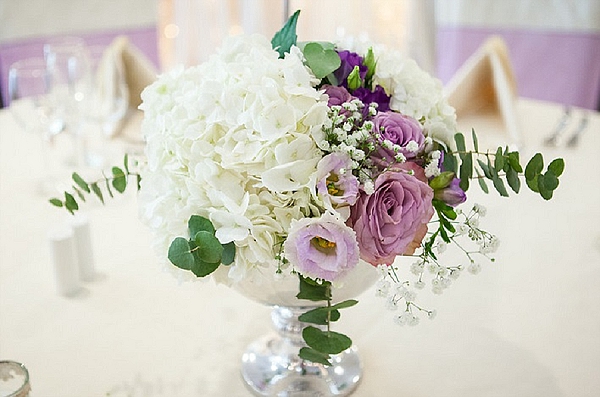 purple wedding flowers lilac centrepieces footed bowls white hydrangeas purple lisianthus roses  Mallory Court Passion  for Flowers Florists