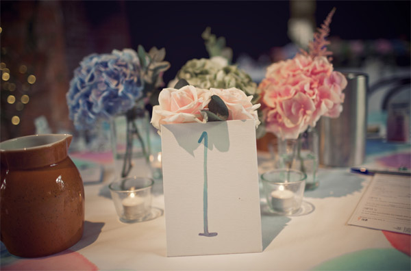 blue pink hydrangeas in bottles centrepieces shustoke farm barns summer wedding florist passion for flowers