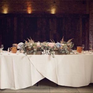 shustoke farm barns summer wedding top table florist passion for flowers blue pink rustic crates