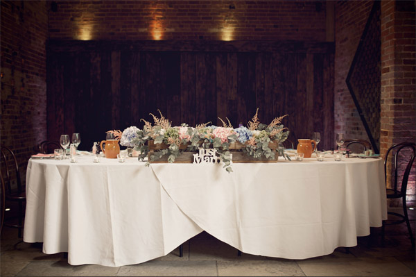 shustoke farm barns summer wedding top table florist passion for flowers blue pink rustic crates