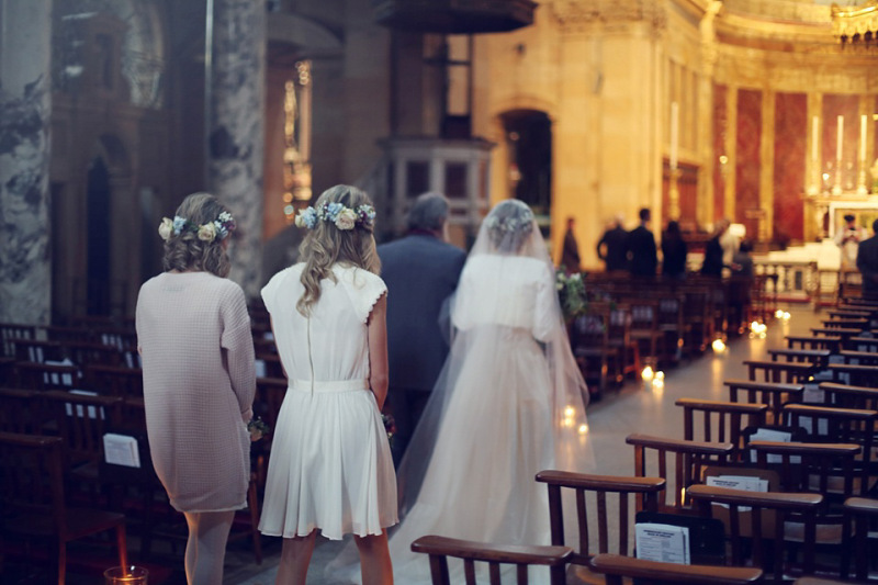 church decorated with glass cylinder candles down the aisles 