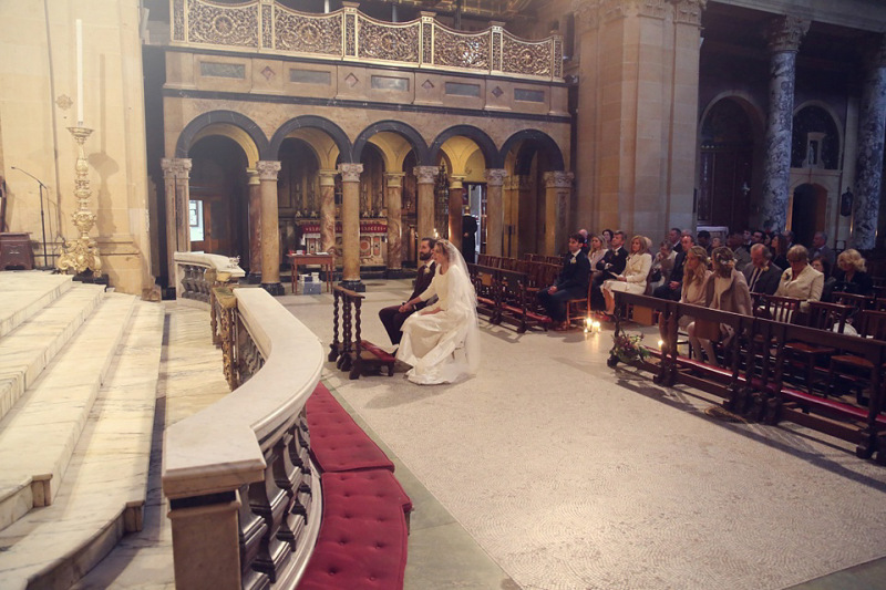 church decorated with glass cylinder candles down the aisles 