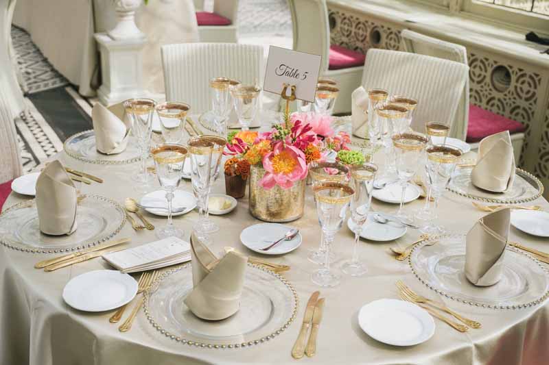 Luxe wedding centrepieces bright coral flowers in gold vases at Kilworth House reception by Passion for Flowers (1)