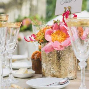 Luxe wedding centrepieces bright coral flowers in gold vases at Kilworth House reception by Passion for Flowers (2)