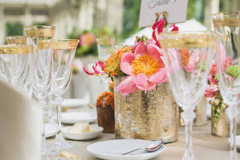 Luxe wedding centrepieces bright coral flowers in gold vases at Kilworth House reception by Passion for Flowers (2)