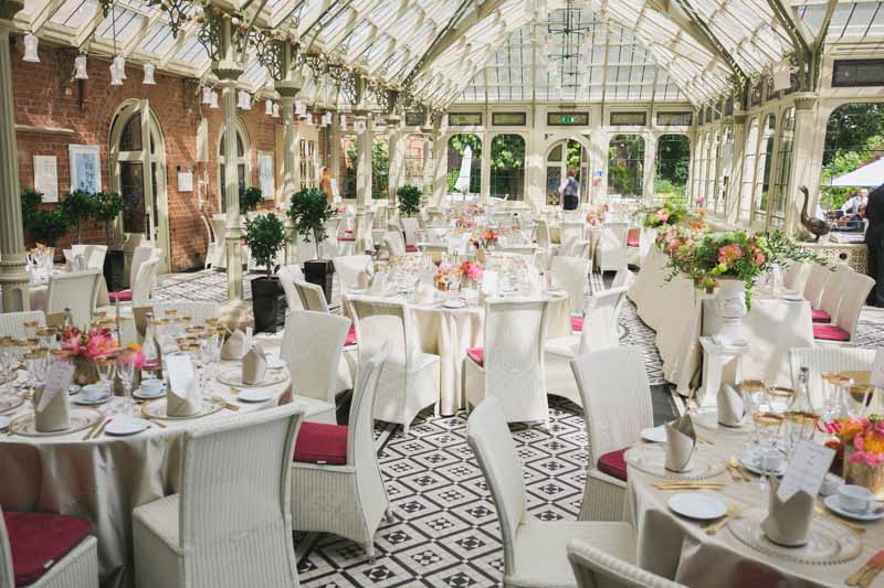 Luxe wedding centrepieces bright coral flowers in gold vases at Kilworth House reception by Passion for Flowers (3)