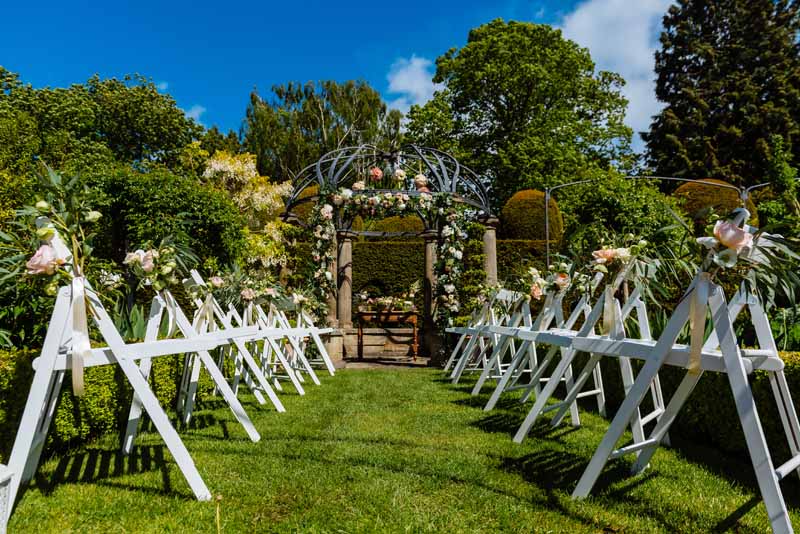 Outdoor-wedding-ceremony-aisle-decorations-of-flowers-and-trailing-ribbon-peach-Juliet-David-Austin-roses-by-Passion-for-Flowers