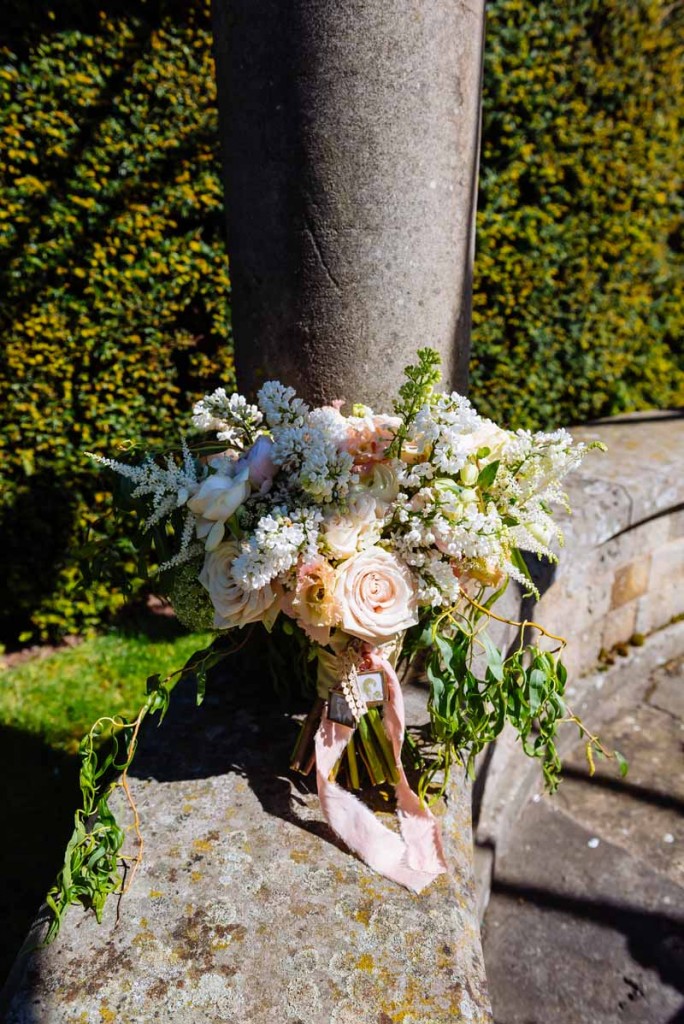 Passion-for-Flowers-free-form-natural-wedding-bouquet-tied-with-silk-ribbon-and-small-locket-peach-and-cream-roses-with-foliage