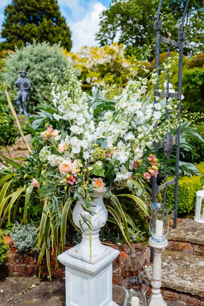 Wow-factor-urn-framing-entrance-to-outdoor-ceremony-peach-cream-green-florlas-Wedding-florist-Passio-for-Flowers