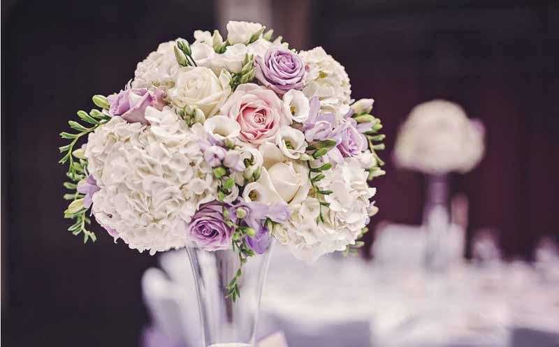 tall glass vases wedding centrepieces at hampton manor wedding flowers by passion for flowers