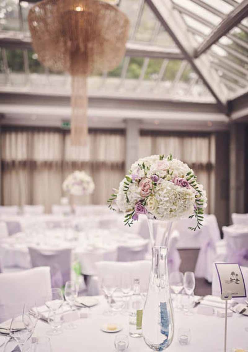 tall glass vases wedding centrepieces lilac and white flowers at hampton manor wedding flowers by passion for flowers