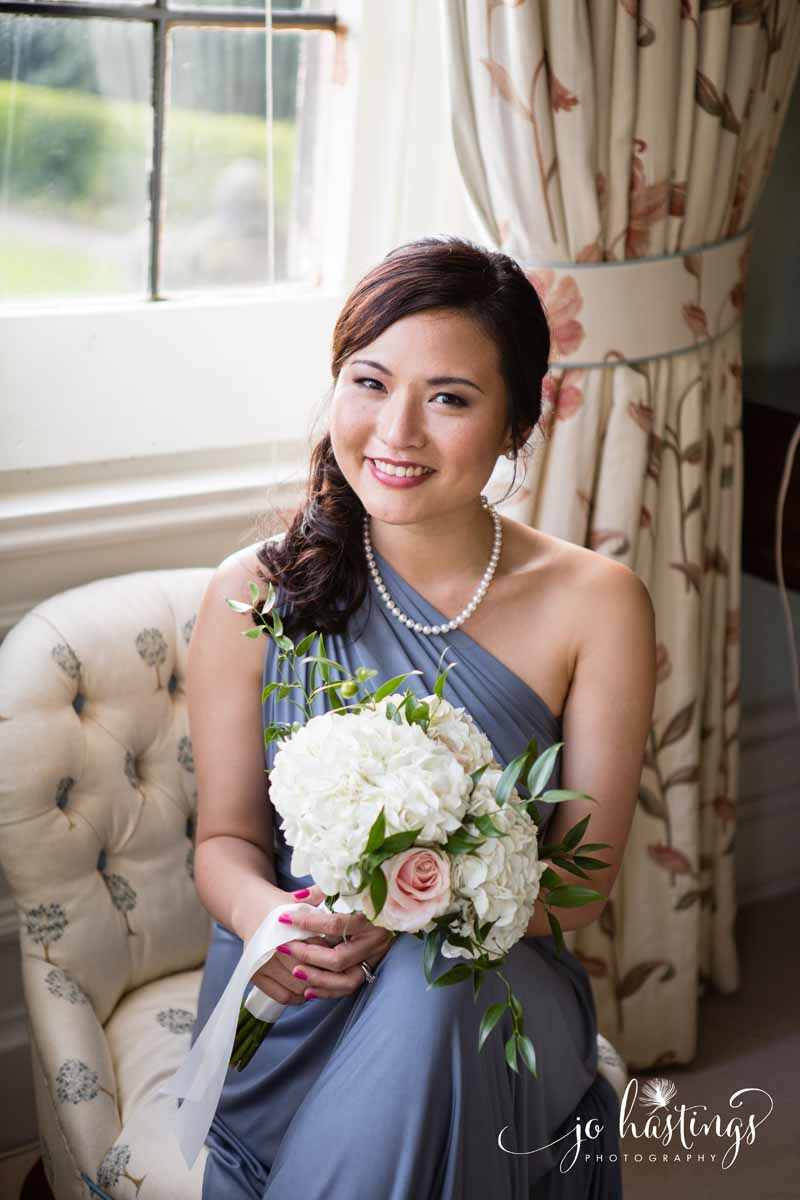 Dusty blue bridesmaids dress with white and pink bouquet