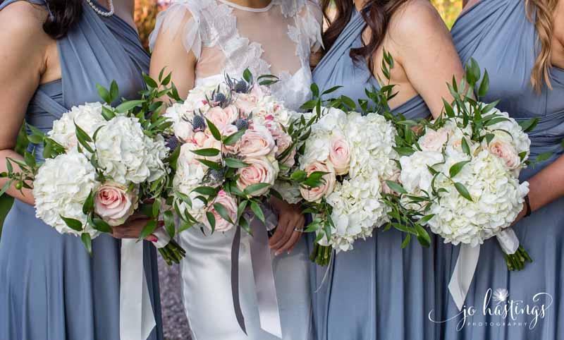 dusty blue bridesmaids dresses dusky pink roses, blue thistles and white hydrangea bouquets (2)