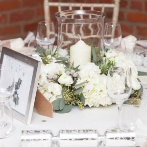 winter wedding centrepiece idea by @kmorganflowers Passion for Flowers grey and white ring of flowers around hurricane lantern