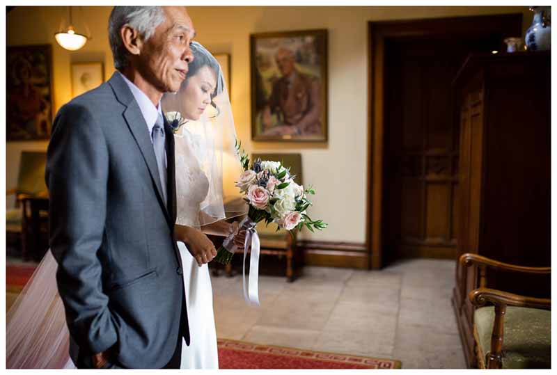 Elegant bride and her father walking into the wedding ceremony