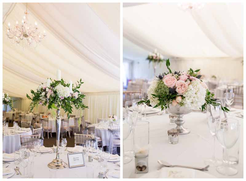 Two centrepieces that could work together in a marquee tall candelabra and low footed bowls both silver with green white and dusty blue flowers