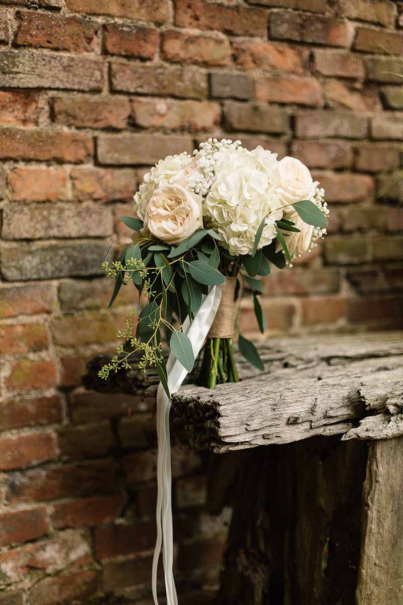 Cream-roses-and-hydrangea-bouquet-tied-with-rustic-chord-and-trailing-ribbon-Florist-Passion-for-Flowers-@kmorganflowers