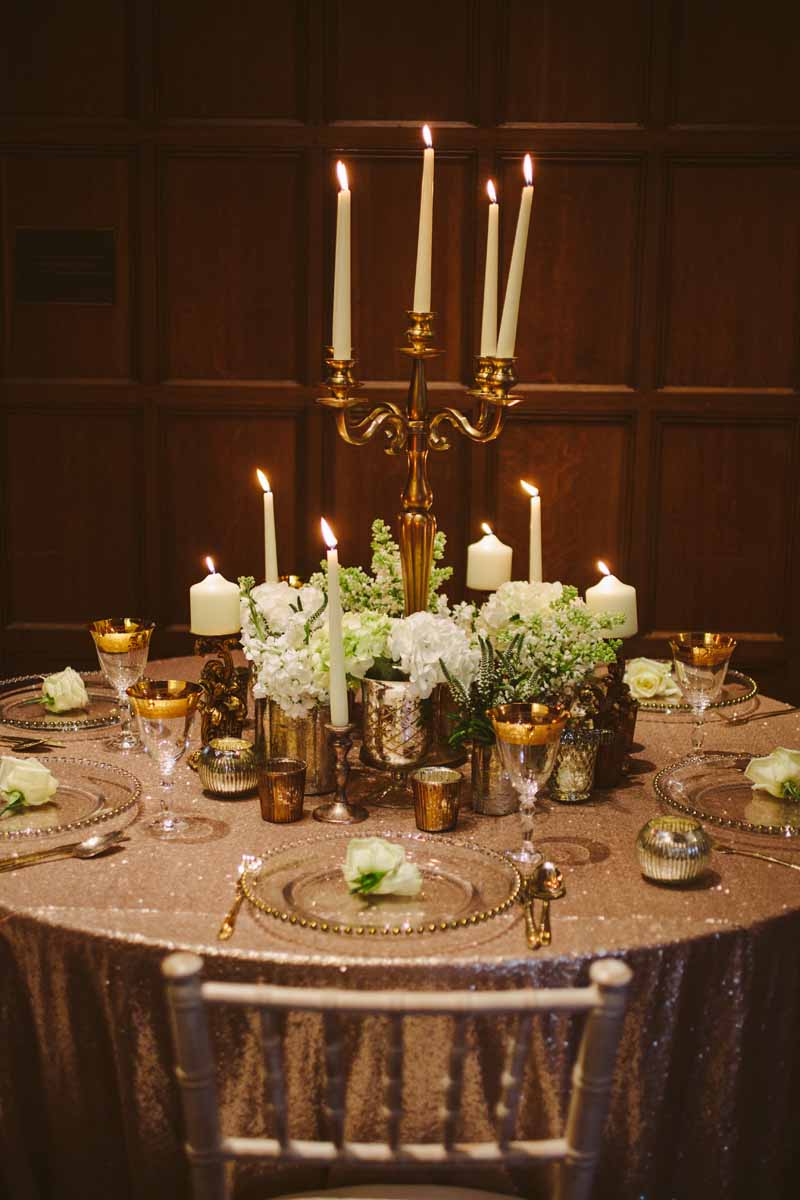 Elegant gold wedding centrepieces candleabra with white flowers by Passion for Flowers @kmorganflowers (1)