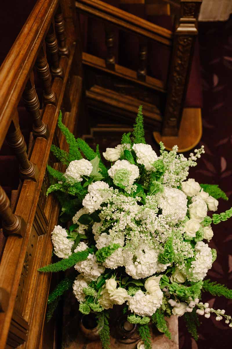 Green and white flowers in urns