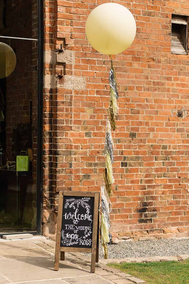 Shustoke-Farm-Barns-Wedding-balloons-and-chalkboard-welcome-sign