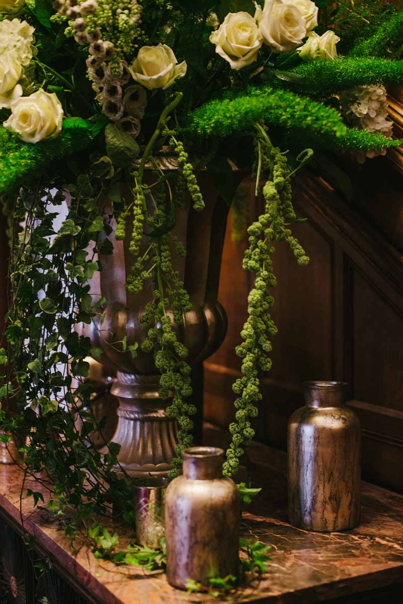 Stunning gold urn with antique gold vases and vessels around the base on a wedding entrance table by @kmorganflowers (1)