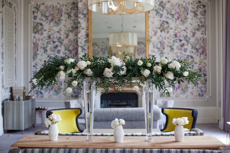 Elevated florals above long tables for weddings by Passion for Flowers shown here at Hampton Manor