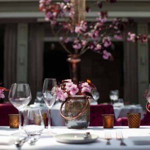 Top table wedding flowers bright pink blossom in bronze low vases and votives at Hampton Manor by Passion for Flowers @kmorganflowers