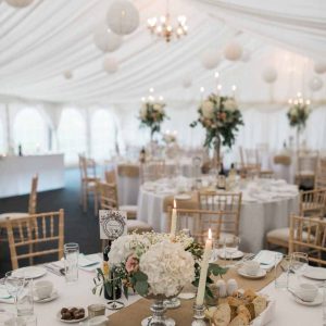 Marquee wedding at Wethele Manor footedbowl centrepieces mixed with candelabra centrepieces for summer wedding