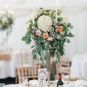 Organic style wedding candelabra centrepieces using eucalyptus hydrangeas David Austin roses and gypsophila by Passion for Flowers at Wethele Manor