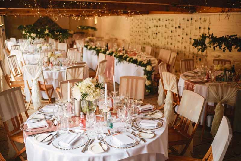 curradine barns wedding florist passion for flowers flower wall backdrop hanging flower hoops above tables and low footed bowl centrepieces