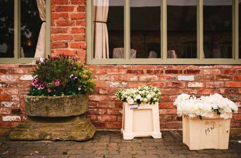 passion for flowers wedding florist setting up at curradine barns