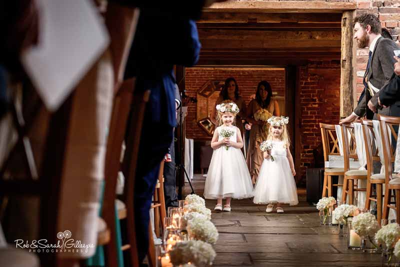 Aisle decorations using hydrangeas with cute flower girls and their flower crowns by @kmorganflowers