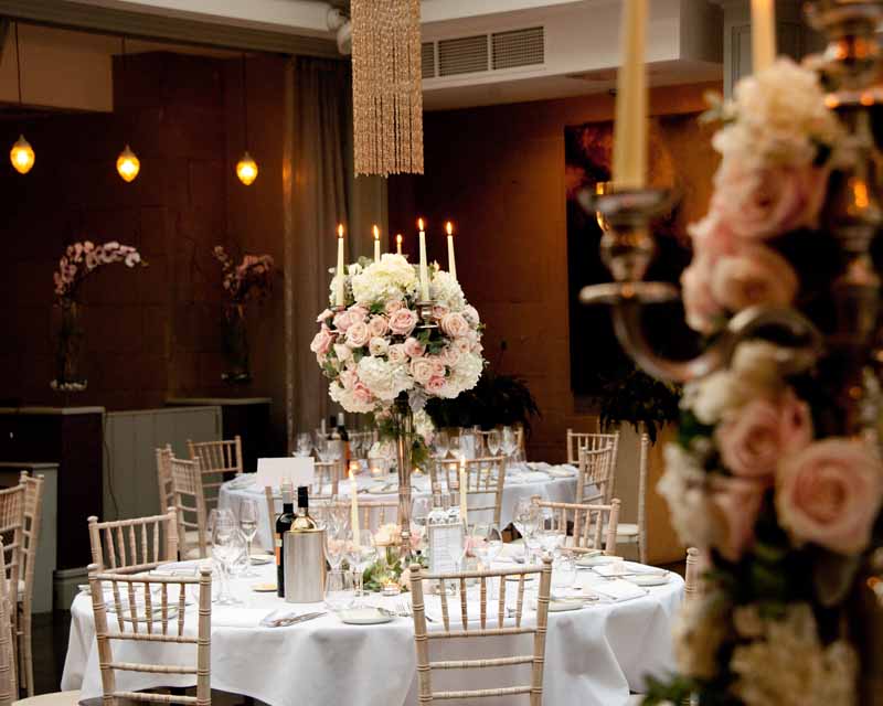 Elegant centrepieces at Hampton Manor - Passion for Flowers Candelabra centrepieces