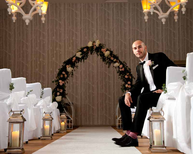 Floral arch for wedding ceremony at Hampton Manor by Passion for Flowers - lanterns for aisle decorations