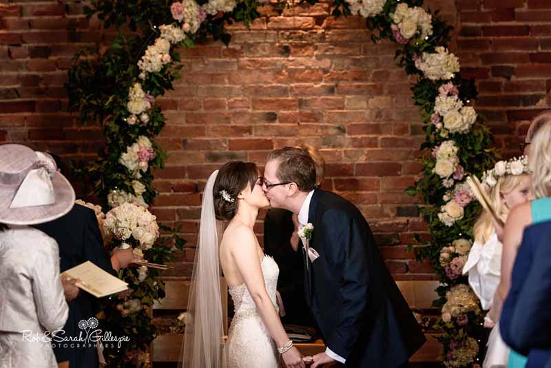 Hydrangea and rose wedding ceremony arch in barn wedding venue Packington Moor by Passion for Flowers @kmorganflowers