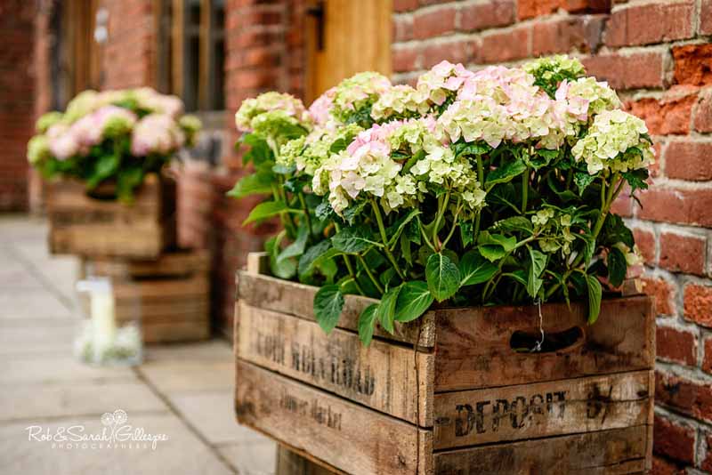 Hydrangea plants in rustic crates for entrance decorations by @kmorganflowers at Packington Moor