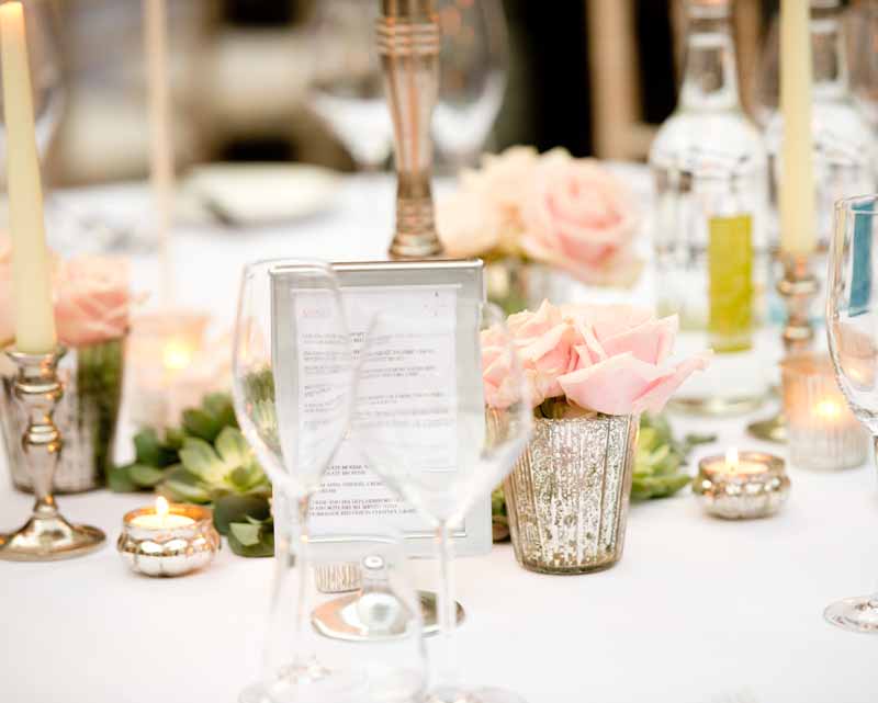 Mercury silver vases and votives with blush pink roses for winter wedding at Hampton Manor