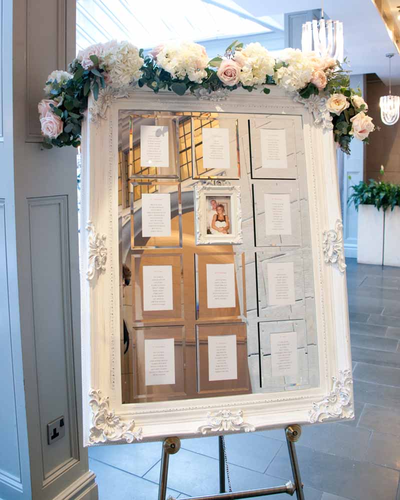 Mirror table plan floral garland by Passion for Flowers Hampton Manor Wedding Florist