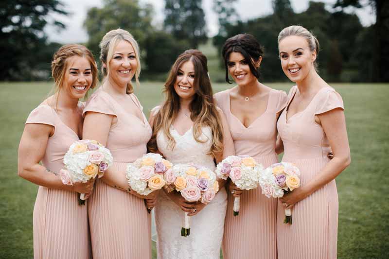 blush-pink-bridesmaids-dresses-with-rose-bouquets-at-compton-verney