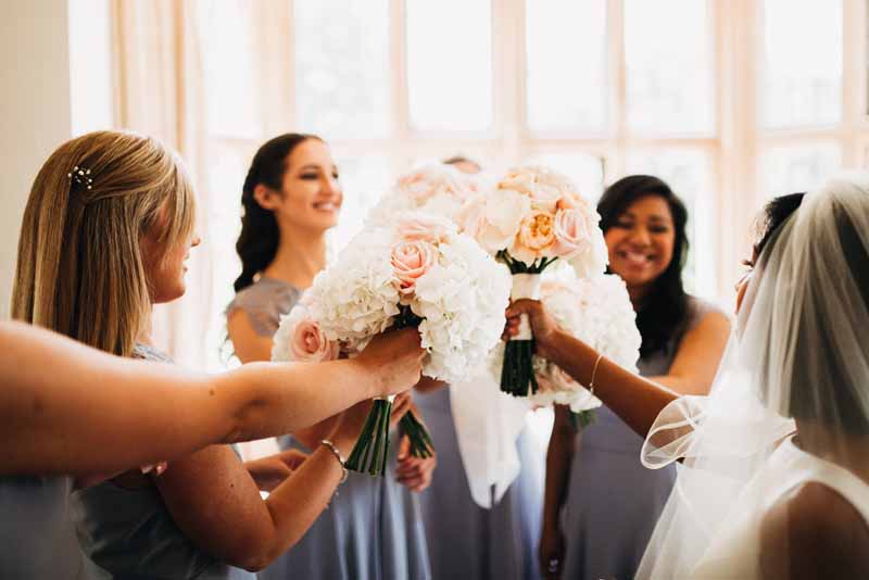 bridesmaids-bouquets-peach-and-blush-pink-roses-grey-dresses-coombe-lodge-bristol