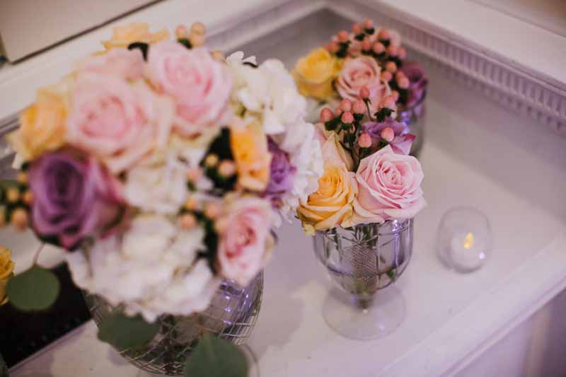 glass-footed-bowls-of-pink-purple-peach-roses-for-wedding-centrepieces-compton-verney-1