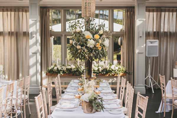 hampton-manor-wedding-tall-centrepieces-bronze-vases-peach-roses-florist-passion-for-flowers