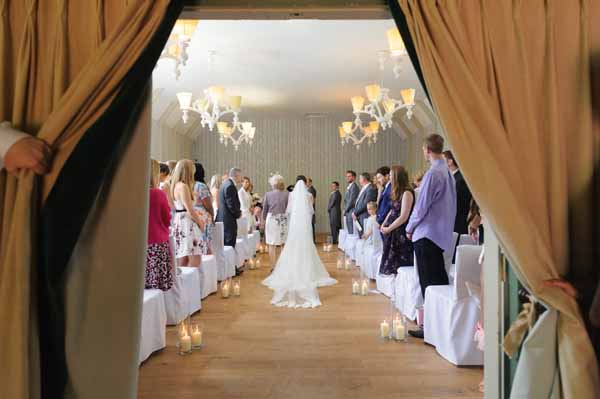 hampton-manor-wedding-ceremony-lanterns-down-aisle-1