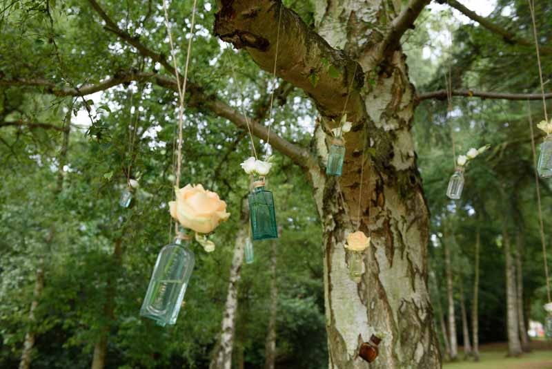 hanging-roses-in-apothecary-bottles-wedding-flowers-1