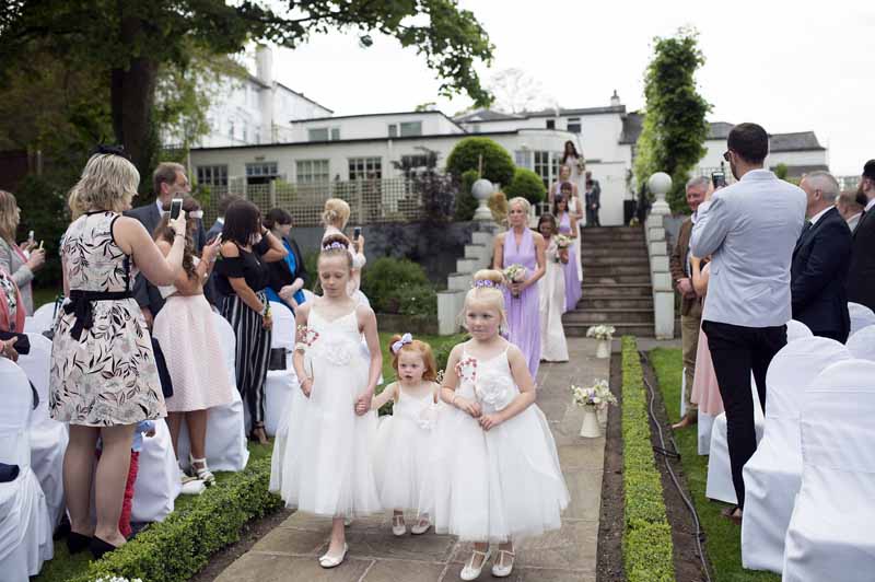 outdoor-wedding-ceremony-at-warwick-house-jugs-down-the-aisle-1