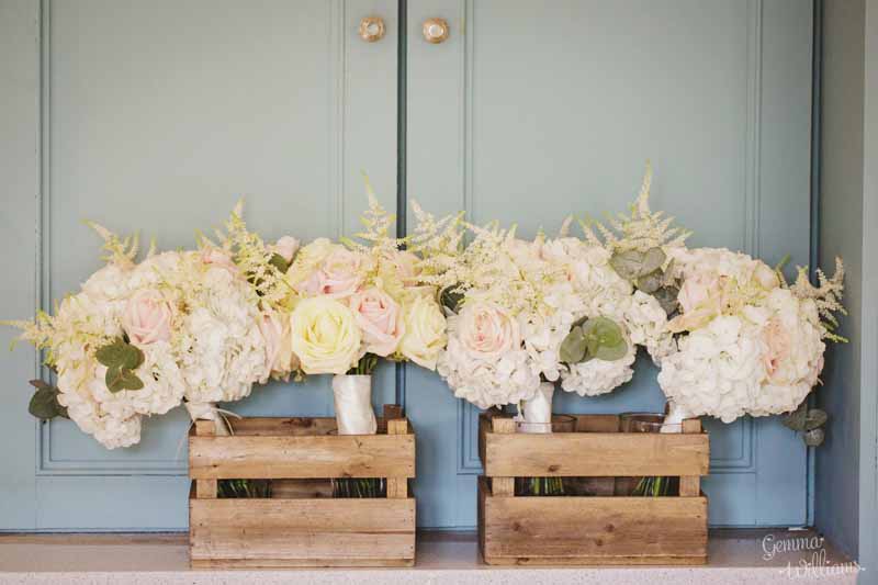 Pretty-bridesmaids-bouquets-delivered-in-wooden-crates.-Hydrangeas-astilbe-avalanche-and-sweet-avalanche-roses