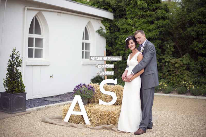 rustic-wedding-details-stack-of-hay-bales-with-bride-and-grooms-initials