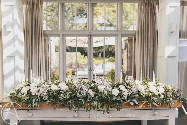 top-table-floral-garlands-with-candle-sticks-wow-factor-hampton-manor-wedding-florist-passion-for-flowers