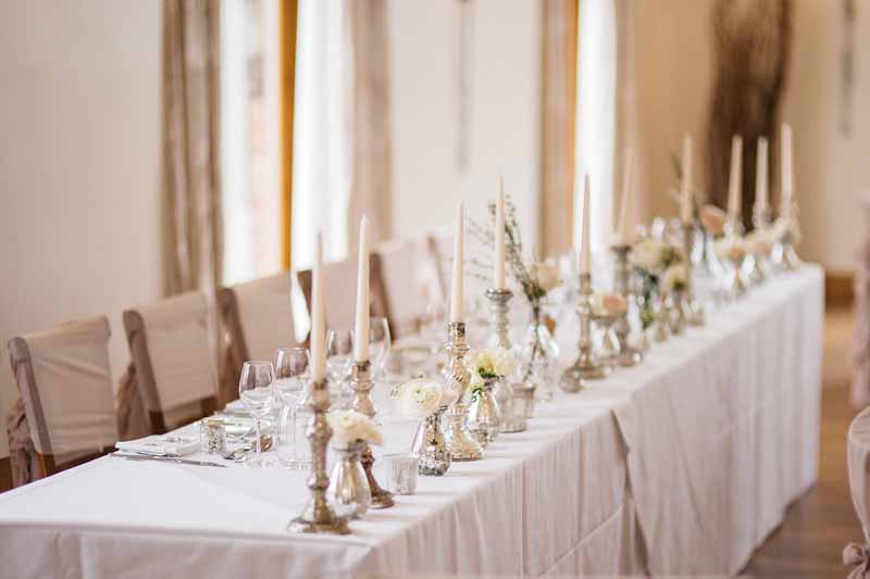 top-table-wedidng-decorations-mercury-silver-candle-sticks-crystal-glass-vases-white-roses-by-passion-for-flowers